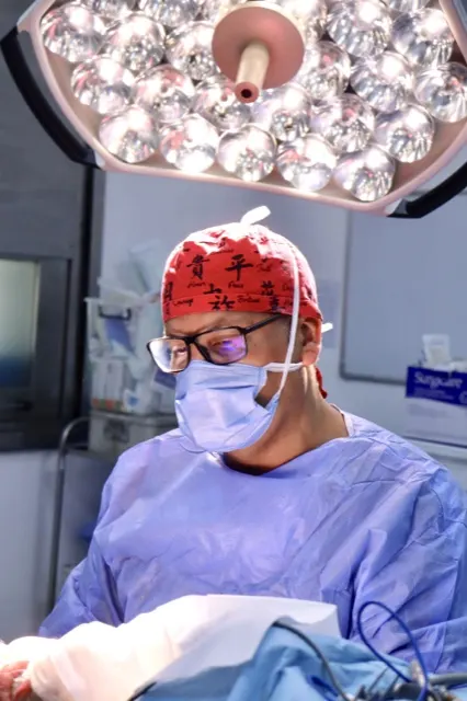 Professional portrait of a surgeon in the operating theatre, surgical cap and mask